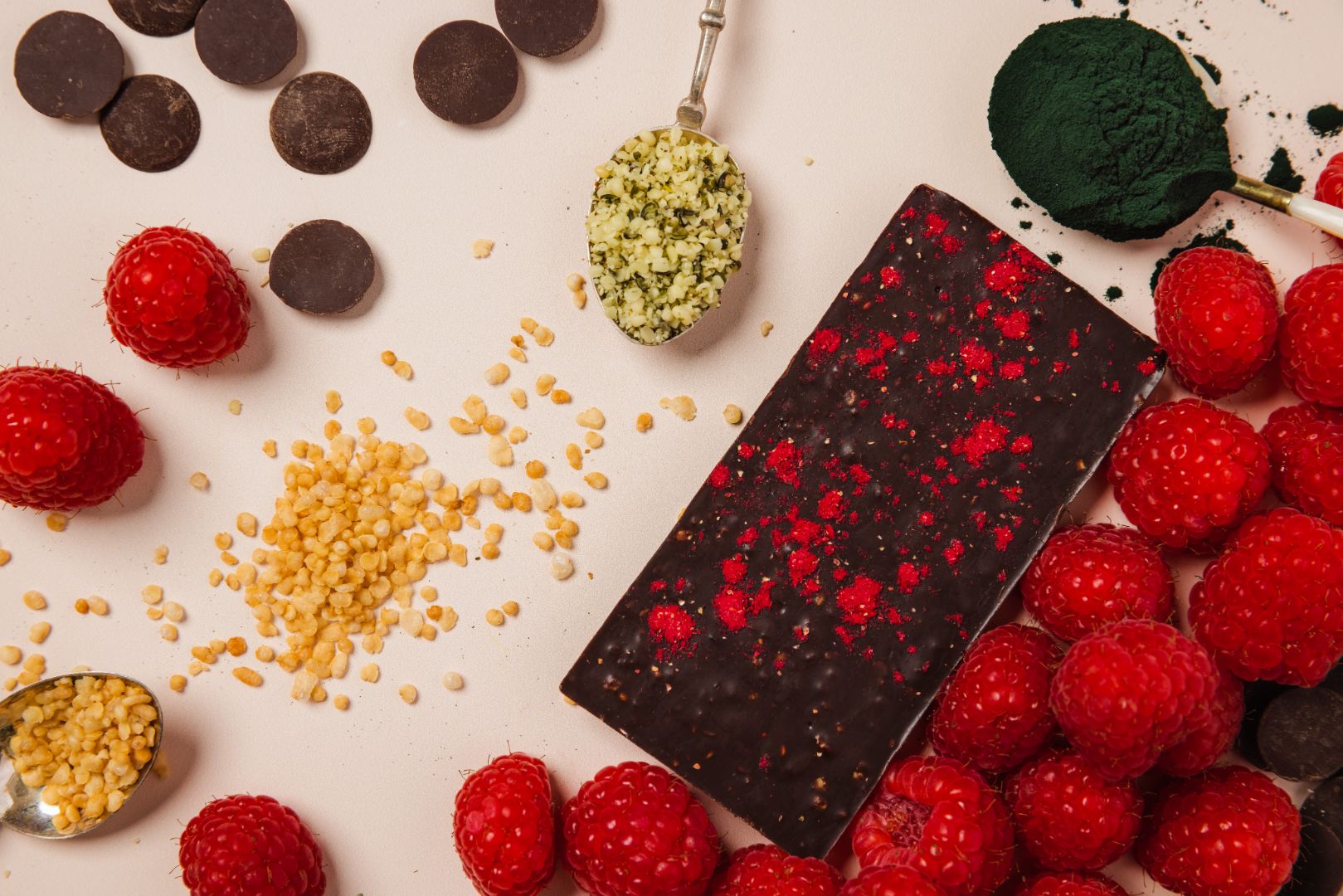Belovd Raspberry Chocolate bar surrounded by its raw ingredients